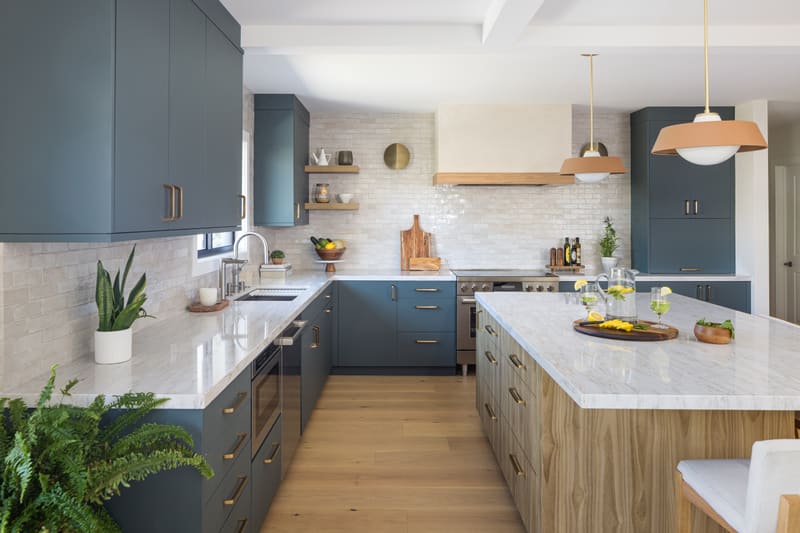 Blue cabinetry with a white oak island