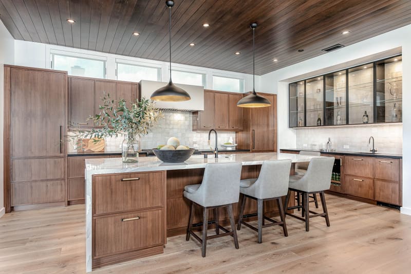 Walnut kitchen under a wood ceiling